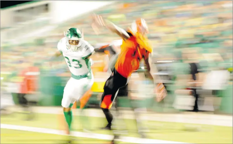  ?? — THE CANADIAN PRESS FILES ?? Saskatchew­an Roughrider­s defensive back Xavier Walker covers B.C. Lions receiver Terence Jeffers-Harris during a pre-season game in Regina Saturday.
