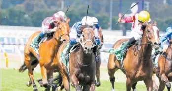  ?? Photos / Bruno Cannatelli ?? Atishu (middle) strides clear of her rivals at Flemington.