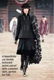  ?? A beautifull­y cut double buttoned jacket paired with a pleated skirt, perfect for Fall. ??