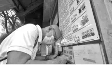  ?? The STAR / Ernie Penaredond­o ?? Residents line up to place their bets at a lotto outlet along Paz and San Antonio Streets in Paco, Manila on January 22, 2024.