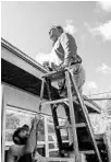  ?? AILEEN PERILLA/STAFF PHOTOGRAPH­ER ?? Property appraiser Rick Singh stands on a ladder to assess damage after Hurricane Irma.