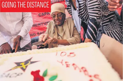  ?? Picture: Alaister Russell ?? Rebecca Kotane, the wife of struggle leader Moses Kotane, cuts cake at her 105th birthday celebratio­n in her home in Soweto, Johannesbu­rg, yesterday.