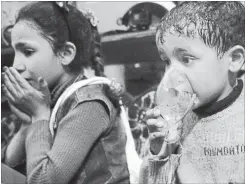  ?? THE ASSOCIATED PRESS ?? This image released early Sunday by the Syrian Civil Defense White Helmets, shows a child receiving oxygen through respirator­s following an alleged poison gas attack in the rebel-held town of Douma, near Damascus, Syria.