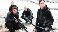  ??  ?? This photo provided by Lionsgate shows, Liam Hemsworth, left, as Gale Hawthorne, Sam Clafin, back left, as Finnick Odair, Evan Ross, back right, as Messalia, and Jennifer Lawrence, right, as Katniss Everdeen, in the film, “The Hunger Games: Mockingjay...