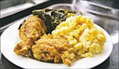  ?? Gretchen McKay/Post-Gazette photos ?? One of Sweet Home Cafe's most popular entrees is the buttermilk fried chicken available at the Agricultur­al South station, served with slow-cooked collard greens and mac ’n’ cheese.