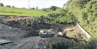  ?? PHOTOS: GERARD O’BRIEN ?? Flume exhumed . . . Part of a wooden flume, or spillway, lies below the arm of the digger. Contractor­s are repairing the Ross Creek reservoir dam.