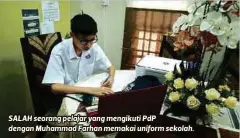  ??  ?? SALAH seorang pelajar yang mengikuti PdP dengan Muhammad Farhan memakai uniform sekolah.