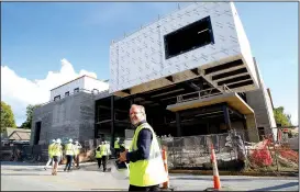  ?? NWA Democrat-Gazette/DAVID GOTTSCHALK ?? Jonathan Marvel with Marvel Architects watches as guests enter the new TheatreSqu­ared building.