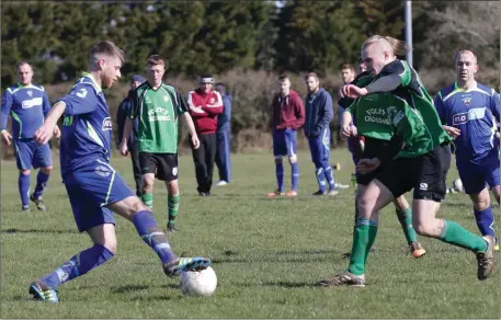  ??  ?? Stephen O’Leary of New Ross Town on the ball as Crossabeg’s Oisín O’Connor closes in during their Division 2 match on Sunday.