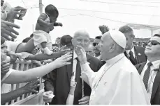  ?? Pool via Associated Press ?? n A bruised Pope Francis is shown a baby to bless on Sunday after his arrival at Cartagena, Colombia. Pope Francis wrapped up his Colombia trip with a deeply personal final day honoring St. Peter Claver, a fellow Jesuit who ministered to hundreds of...