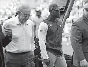  ?? JOHN MCCALL/SOUTH FLORIDA SUN-SENTINEL VIA AP ?? Dolphins owner Stephen Ross, left, walks off the field next to then-head coach Brian Flores after the team’s loss to Atlanta on Oct. 24, 2021 in Miami Gardens, Fla.