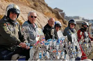  ?? AFP/GETTY ?? Hot wheels: Six scooter club members pose for sunny picture in Bournemout­h