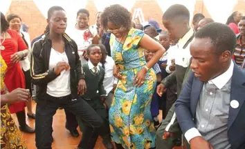  ??  ?? Motherly love. . .Dr Amai Mugabe on the dance floor with children from different charitable homes during her 51st birthday celebratio­ns in Mazowe last year