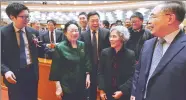  ?? ZHOU WEIHAI / FOR CHINA DAILY ?? Tu Youyou (second left) receives congratula­tions from her research partners at the ceremony of the State Science and Technology Awards in Beijing on Monday.