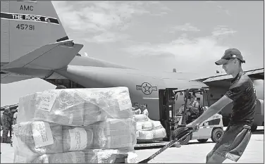  ?? U.S. Air Force/STAFF SGT. JAEL LABORN ?? Cargo provided by the U.S. Agency for Internatio­nal Developmen­t is unloaded from an Air Force plane by Peruvian workers in Lima, Peru, earlier this month. Two C-130 aircraft from Little Rock Air Force Base are transporti­ng supplies and personnel to...