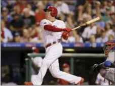  ?? MATT SLOCUM — THE ASSOCIATED PRESS ?? New Phillies slugger Rhys Hoskins puts a swing on a ball in a game against the New York Mets Aug. 11.