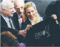  ?? (Michaela Rehle/Reuters) ?? US SEN. John McCain receives a T-shirt during the 53rd Munich Security Conference yesterday.