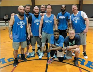  ??  ?? Members of the Blue team celebrate their victory in the championsh­ip game. Pictured are, back row from left: Mike Flynn, Mike Lauer, Bill Lally, Myles Loughlin, Bill Rogers, Tyrone Gavin and Jim Joyce; kneeling: DeAndre Hariot and KJ Sowisdral.