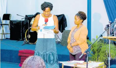  ?? FILE ?? Philippa Davies (left) of the Jamaica Coalition for a Healthy Society (JCHS) reads selections from the HFLE curriculum to Novia Condell-Gibson.