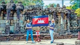  ?? FB ?? Thiago Teixeira (left) and his wife Roma Maria Rozanska-Steffen hold up a Cambodian flag at the Elephant Terrace in Siem Reap province earlier this year.