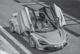  ?? McLaren Automotive ?? THE DIHEDRAL doors swoop open to reveal a spare interior. The seats are minimally adjustable and visibility is quite limited. But the rearview camera helps greatly with backing and parking.