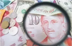  ??  ?? The Singapore dollar is managed against a basket of currencies of its major trading partners and competitor­s. — Reuters photo