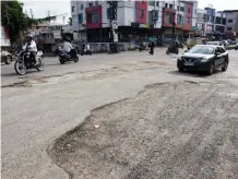  ?? — GANDHI ?? The road at the Bowenpally market, Secunderab­ad, lies in ruins after the recent rains, on Monday.