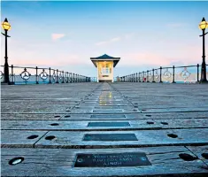  ??  ?? Walk down memory lane: a row of plaques stretching to the end of Swanage Pier