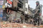  ?? PIC/NAVEEN SHARMA ?? Indian paramilita­ry soldiers patrol a vandalized street after Tuesday's violence in New Delhi, on Thursday