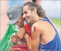  ?? REUTERS ?? Mutaz Essa Barshim of Qatar and Gianmarco Tamberi of Italy after winning gold.