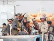  ?? BASHIR KHAN SAFI/AFP ?? An Afghan man carries the dead body of a child (centre) following a NATO coalition airstrike in Kunduz yesterday.