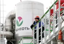  ??  ?? An employee talks on a portable radio set at a refinery in Russia. (Reuters)