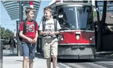  ?? AARON VINCENT ELKAIM/CANADIAN PRESS ?? Connor Cassiotis, left, and his twin brother Wyatt Cassiotis, 10, walk and take public transit to school by themselves.