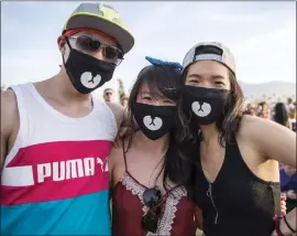  ?? PHOTO BY DAVID BRENDAN HALL ?? The tight-fitting masks worn by Coachella-goers in years past to ward off desert dust may become part of the attire for concertgoe­rs everywhere to ward off the coronaviru­s.