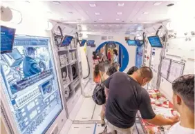  ??  ?? Visitors tour a mock up of an Internatio­nal Space Station module in the Space Camp program at the U.S. Space &amp; Rocket Center.