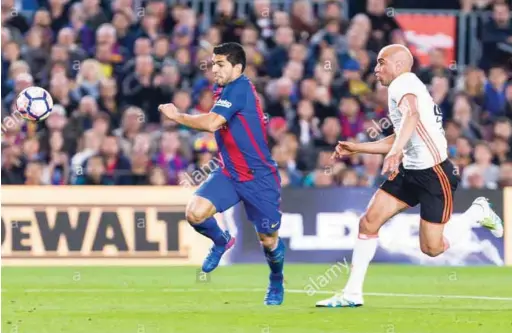  ??  ?? LLuis Suarez (left) and Aymen Abdennour during a match between Barcelona and Valencia earlier