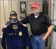  ??  ?? Cayden Regan, one of John E. King’s seventh-grade Ag students, helped sell almost $1,000 worth of Blue & Gold Sausage and earned an FFA jacket which was presented to him by teacher Perry Mason.