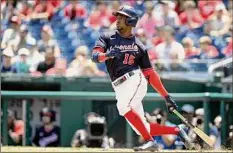  ?? Greg Fiume / Getty Images ?? Victor Robles of the Nationals hits a two-run single against the Rockies on Saturday. He had six RBIs in the first game.