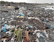  ?? PHOTO: SUPPLIED/TONY KOKSHOORN ?? The storm exposed an old rubbish dump at Cobden on the West Coast, spreading plastic and other trash across the beach.