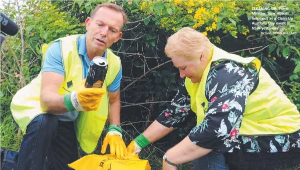  ?? Picture: SIMON BULLARD ?? CLEANING UP: Prime Minister Tony Abbott helps out at a Clean Up Australia Day event in NSW yesterday.