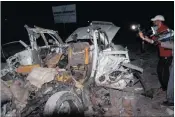  ?? PICTURE: EPA ?? Cameramen film the remains of a destroyed vehicle in front of Banadir beach restaurant at Lido beach in Mogadishu, Somalia, yesterday. Attackers detonated a car bomb at the restaurant and opened fire at security forces. Islamist militant group al...