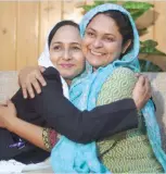  ??  ?? Asma Nawab (R) with a female lawyer after her release in Karachi on Friday. — AFP