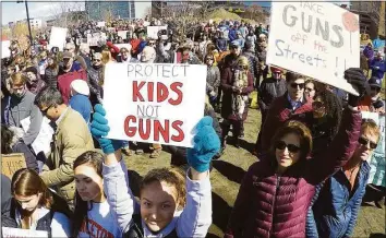  ?? Hearst Connecticu­t Media file photo ?? Ali Jaquiery of Westport holds a sign “Protect Kids, Not Guns” as she joins the estimated 2,000 Fairfield County residents who gathered to listen to student speakers at the March For Our Lives rally at Mill River Park on March 24, 2018 in Stamford.