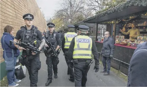  ?? PICTURE: SWNS ?? 0 Armed police on patrol during Edinburgh’s Christmas Market in Princes Street Gardens last year