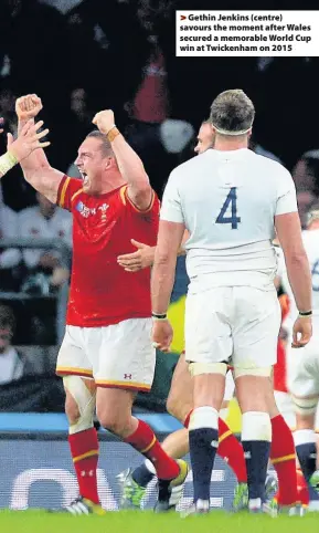  ??  ?? > Gethin Jenkins (centre) savours the moment after Wales secured a memorable World Cup win at Twickenham on 2015