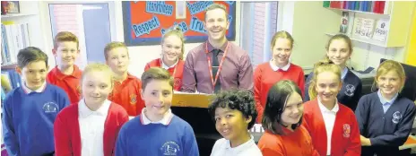  ??  ?? ■ School pupils wrote their own song with songwritin­g doctor Larry Williams (centre) to sing at their leavers’ service