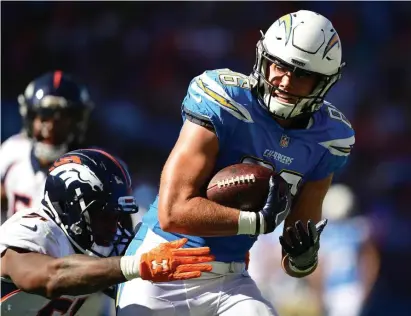  ?? GeTTy iMages file; Below, denver posT file ?? ‘RICH HISTORY’: Former Chargers tight end Hunter Henry is elated to play alongside former Titans tight end Jonnu Smith, below, after they both signed with the Patriots in free agency.