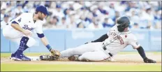  ?? MARCIO JOSE SANCHEZ/AP ?? SAN FRANCISCO GIANTS’ JORGE SOLER (right) is tagged out by Los Angeles Dodgers third baseman Chris Taylor (left) after a single by Lamonte Wade Jr. during the rst inning of a game on Monday in Los Angeles.