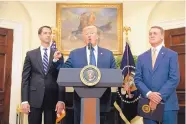  ?? EVAN VUCCI/ASSOCIATED PRESS ?? President Donald Trump, flanked by Sen. Tom Cotton, R-Ark., left, and Sen David Perdue, R-Ga., talks about the new legislatio­n in the White House on Wednesday.