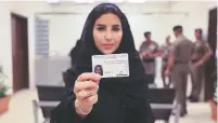  ?? SAUDI INFORMATIO­N MINISTRY VIA AP ?? Esraa Albuti, an executive director at Ernst & Young, displays her driver’s license Monday at the General Department of Traffic in Riyadh, Saudia Arabia.